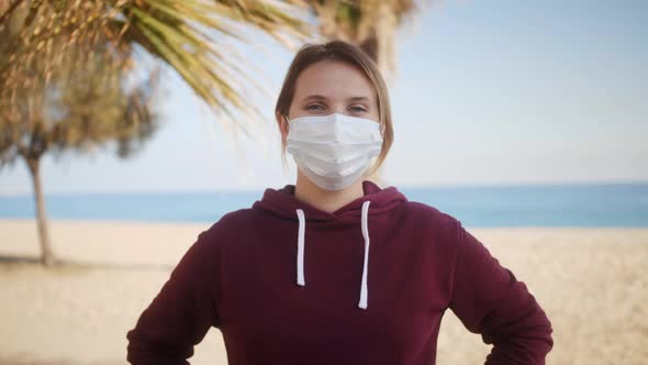 Portrait of Woman Wearing Face Mask Standing Outdoors alt