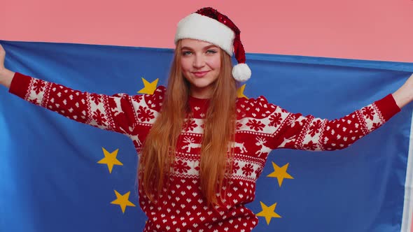 Girl in Christmas Sweater Waving European Union Flag Smiling Cheering Democratic Laws Human Rights alt