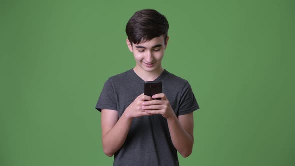 Young Handsome Iranian Teenage Boy Against Green Background alt