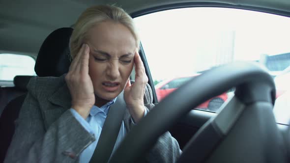 Mature Female Driver Massaging Temples, Suffering Terrible Headache in Car, Pain