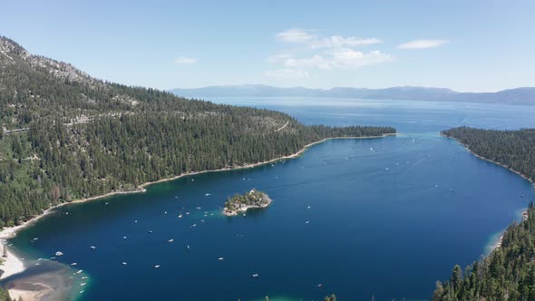 Wide panning aerial shot of Emerald Bay with boat traffic in Lake Tahoe. 4K alt