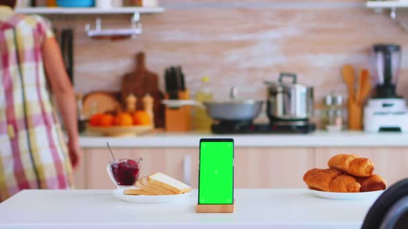 Phone with Green Screen Next to Baked Pastry alt