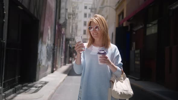 Smiling Attractive Woman Portrait Using Phone at Urban City Streets Buildings alt