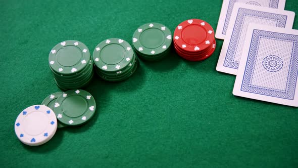 Playing cards and casino chips on poker table 4k alt