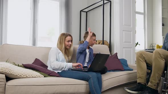 Man in Wheelchair Talking with Beautiful Loving Wife and Attractive Lucky Small Son alt