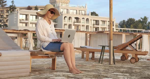 Working on laptop on travel vacation. alt