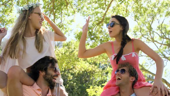 Friends boys carrying girls on their shoulders alt