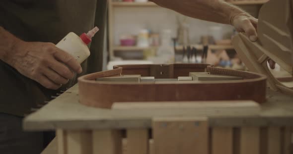 Luthier removing guitar mold top
