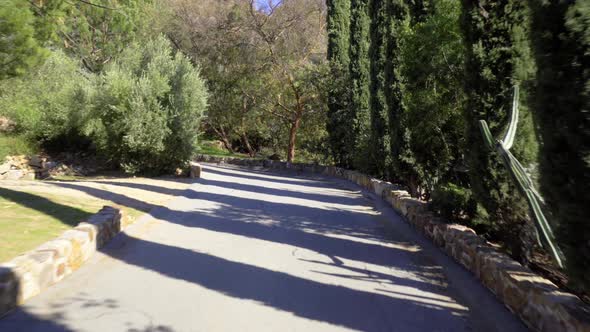 Driving uphill a narrow winding road in the countryside. Point of view alt