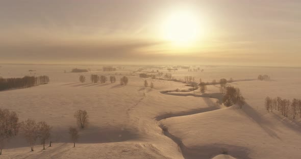 Aerial View of Cold Winter Landscape Arctic Field Trees Covered with Frost Snow Ice River and Sun alt