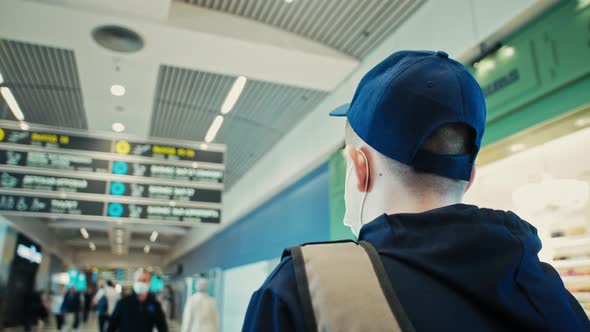 Man Looks at Information Board alt