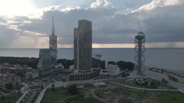 Aerial shot of alphabetic tower, skyscrapers and embankment of beautiful city of Batumi, Georgia alt