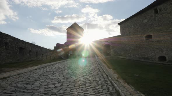 Sun shining at Kamianets-Podilskyi Castle alt