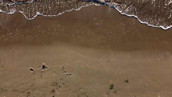 Top View of Texture Waves Sandy Beach
