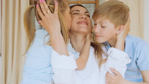 Tender Loving Mother with Son and Daughter Children Kids Hug Mom and Kiss Her