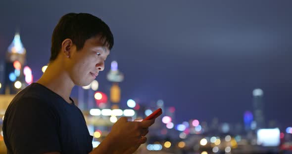Man use of mobile phone at night alt