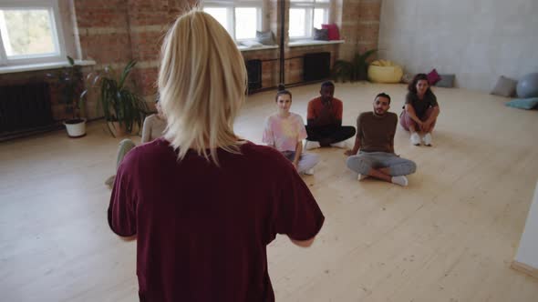 Group of Diverse Students Listening to Dance Teacher alt