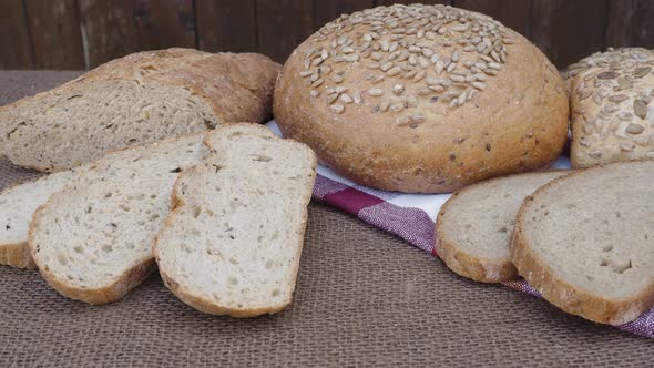 Fresh bread on table. Baked dark bread and sliced bread.