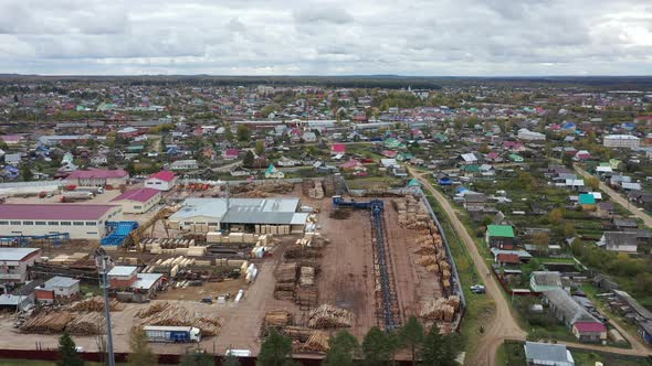 Aerial View of A Large Sawmill Located in Village. Modern Woodworking Factory with Sorting Line alt