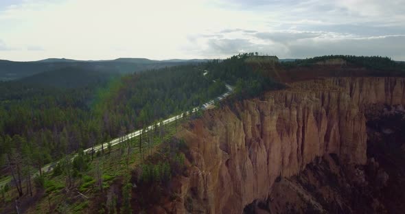Aerial video as a white trailer rides along the highway in Zion National Park, Utah alt