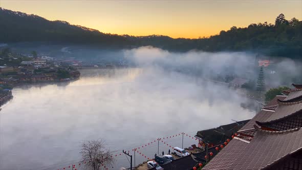 Sunrise with Fog Over Ban Rak Thai Chinese Village Near a Lake in Mae Hong Son Thailand alt