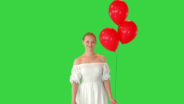 Smiling Young Woman Wearing White Dress with Balloons on a Green Screen Chroma Key alt