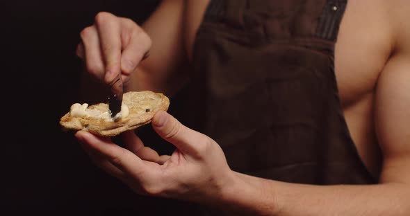 Young Sexy Man Seductively Spreads Butter On Bread