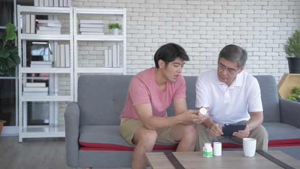 Family concept. Father and son are studying drug use information together. 4k Resolution. alt