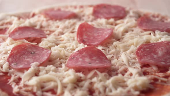 Camera follows putting sliced mushrooms on a pizza dough. Slow Motion. alt