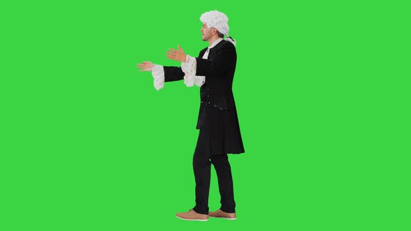Man Dressed Like Wolfgang Amadeus Mozart Conducting an Orchestra on a Green Screen, Chroma Key. alt