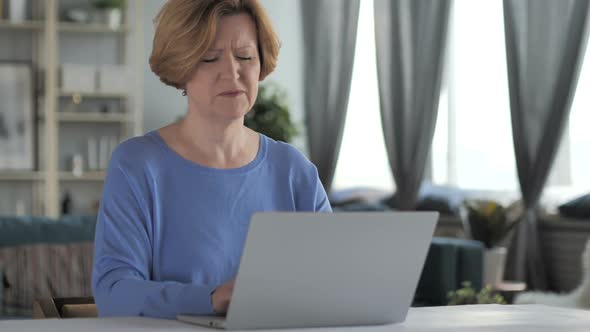 Tired Old Senior Woman with Neck Pain Working on Laptop alt