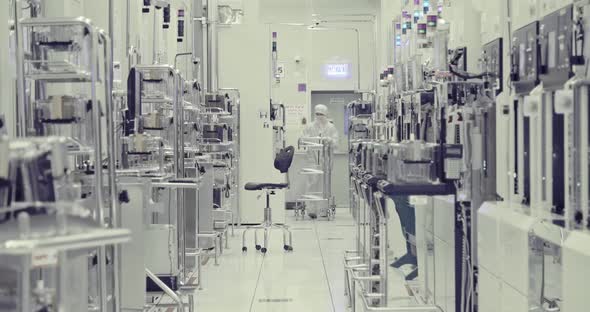 Workers in clean suits in a Semiconductor manufacturing facility alt