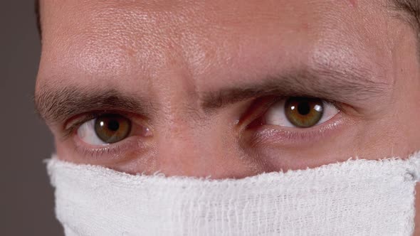 Portrait of Young Man in Protective Gauze Mask, Protection Coronavirus COVID-19 alt