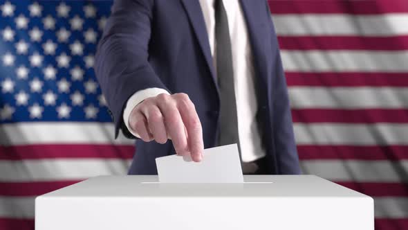 Voting. Man Putting a Ballot into a Voting Box with USA Flag on Background.