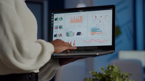 Close Up of Dark Skin Woman Typing on Laptop Standing in Start Up Office alt