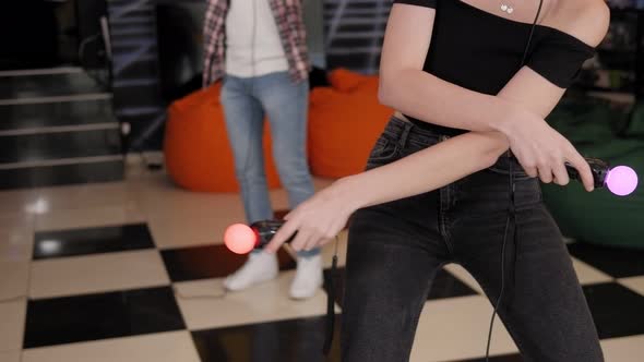 Two Teenagers Playing Video Games Using a Virtual Reality Headset with Glasses alt