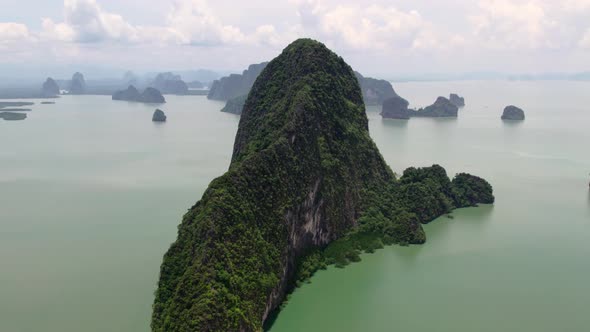 Fly up and towards island in Phang Nga bay, Thailand alt