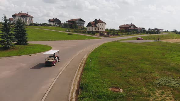 Bride and Groom Ride a Carriage in the Park on a Summer Day alt