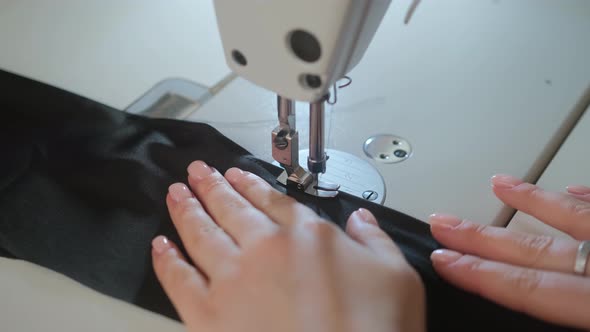 Sewing Machine Needle in Motion. Close-up of sewing machine needle rapidly moves up and down alt