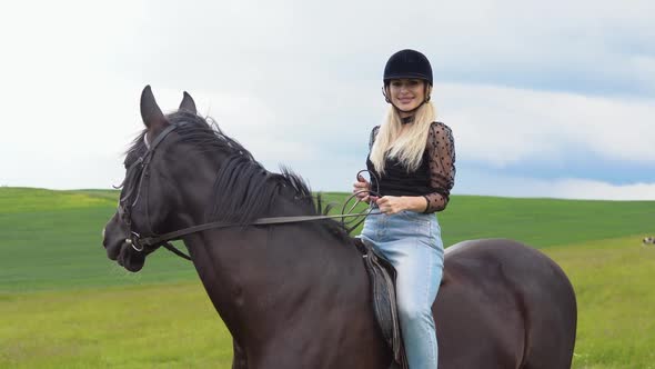 Glamorous Young Woman in a Helmet Trendy Blouse with Translucent Lush Sleeves and Light Jeans alt