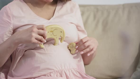Pregnant Woman Playing Wooden Baby Toys alt