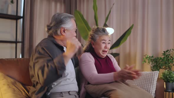 old mature asian couple cheering sport games competition togethe alt