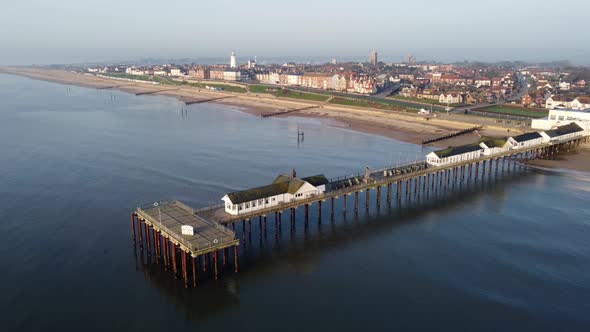 Southwold Pier in Suffolk and the town of Southwold just after Sunrise. Shot with a drone looking fr alt