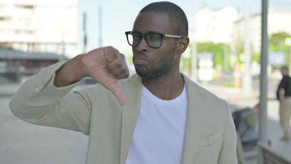 Thumbs Down By African Man Standing Outdoor alt