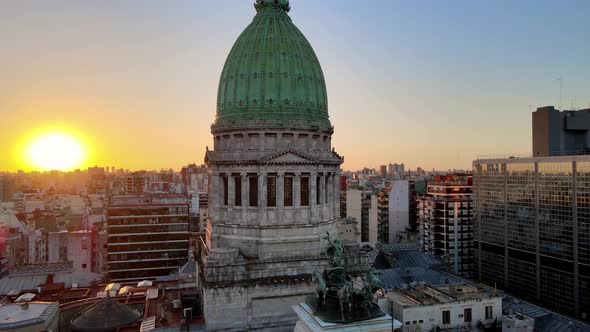 Aerial orbit of Argentine Congress Palace green bronze dome surrounded by Buenos Aires buildings at alt