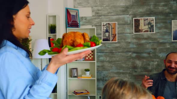 Follow Shot of Young Woman with Roasted Chicken alt