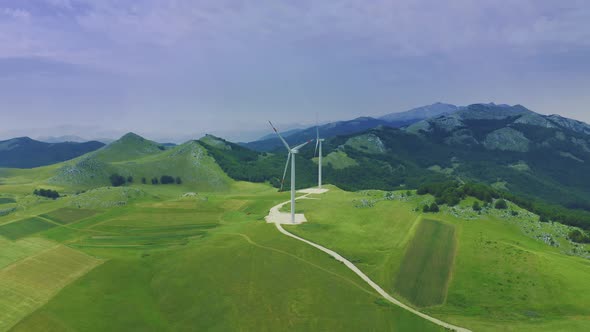 Green Meadow with Wind Turbines Generating Electricity alt