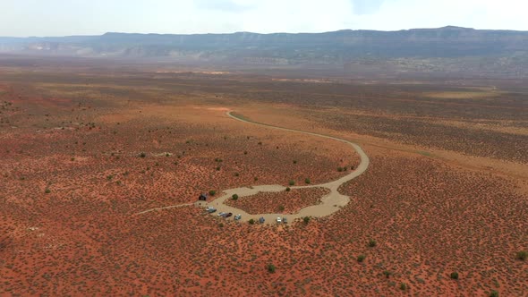 Cars Parked In The Desert Road In The Middle Of Nowhere In Utah. - Drone Orbit Shot alt