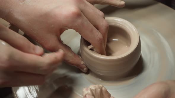 Working with Clay on a Potter's Wheel