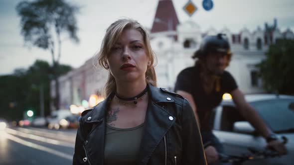 Tattooed Girl Hipster in Leather Jacket and Choker is Standing By Road alt